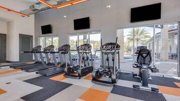 A gym with treadmills, ellipticals, and a stationary bike.