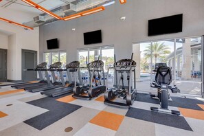 A gym with treadmills, ellipticals, and a stationary bike. - Sr2684 - 4BR House With Pool Near Disney Parks (Kissimmee)