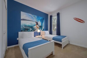 A room with two beds, a large ocean-themed painting, and a surfboard decal on the wall. - Sr2684 - 4BR House With Pool Near Disney Parks (Kissimmee)