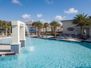 A clear blue pool with lounge chairs and palm trees, surrounded by buildings. - Sr2684 - 4BR House With Pool Near Disney Parks (Kissimmee)