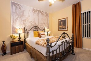 A bedroom with a large bed, two bedside tables, a nightstand, a ceiling fan, a window with curtains, and a wall mural. - Tu220 - 5BR House With Pool Near Disney Area (Davenport)