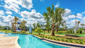 A swimming pool with a tiled deck, palm trees, and a clear blue sky. - Sl4751-208 - 3BR Apartment Near Disney (Kissimmee)