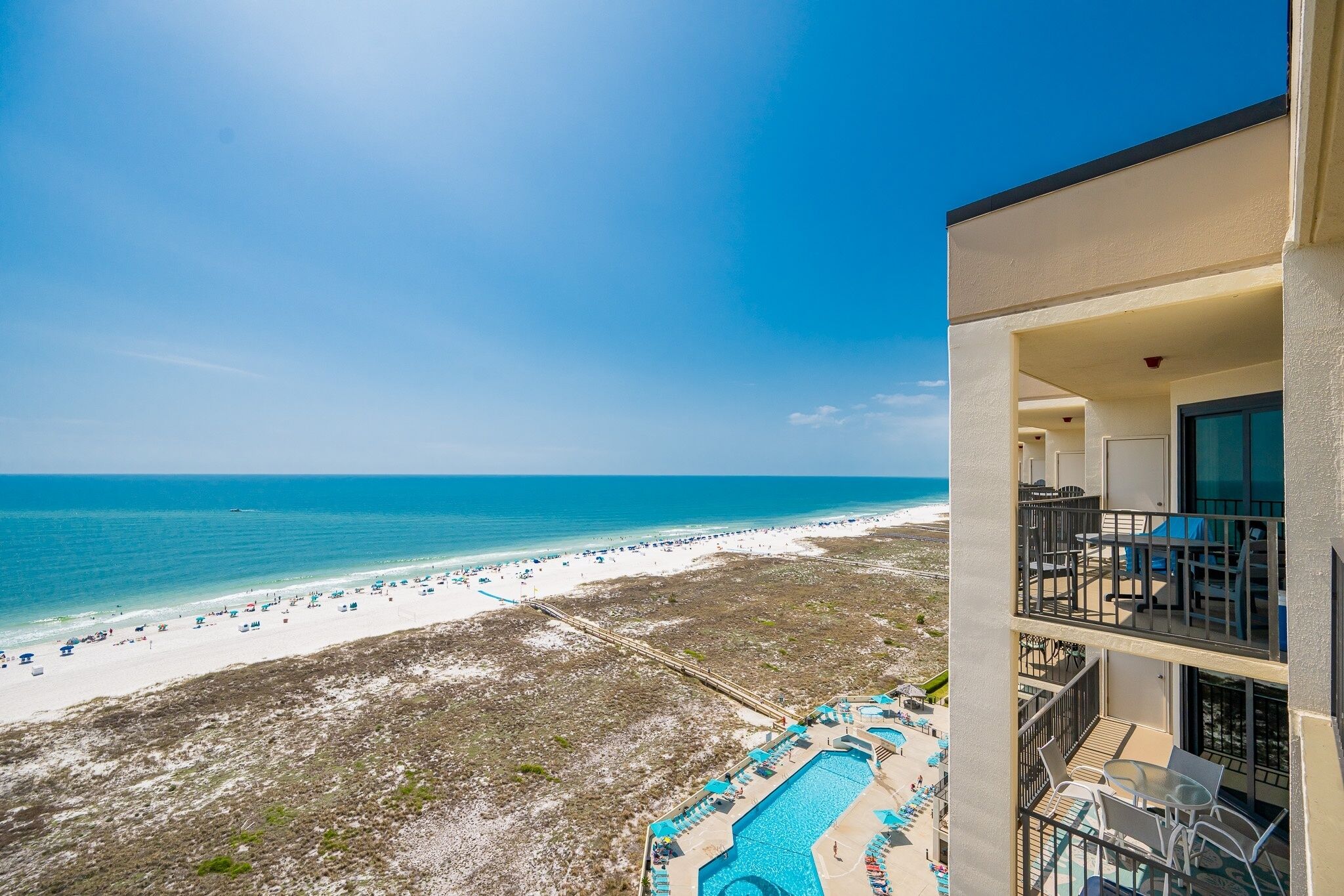 A beachfront hotel with a pool, beach, and ocean view.