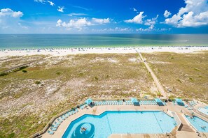 A resort with a large pool, beach access, and a clear view of the ocean. - Phoenix Vii 71010 2 Bedroom Condo (Orange Beach)
