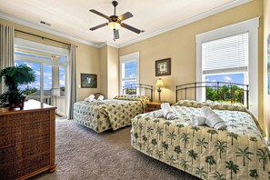 A hotel room with two beds, a ceiling fan, a window with a view, and a plant on the left side. - High Cotton: Inlet Views, Private Dock, Pool & Easy Beach Access (Murrells Inlet)