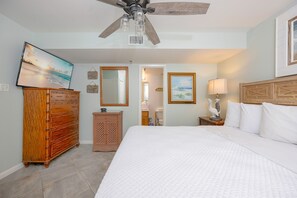 A bedroom with a large bed, wooden dresser, and a ceiling fan. - Phoenix Iii 3047 1 Bedroom Condo (Orange Beach)