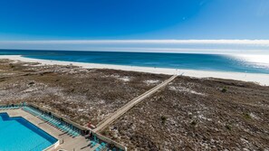 A beach resort with a swimming pool, beach access, and a clear view of the ocean. - Phoenix Vii 7804 2 Bedroom Condo (Orange Beach)