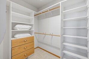 A walk-in closet with open shelves, a wooden dresser, and a ballet barre. - Panoramic Ocean Views, Grill, Wraparound Decks (Pacific City)