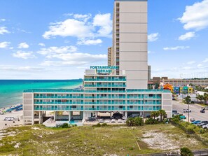 A hotel with multiple floors, a beach view, and a parking area. - Beachfront Studio at Fontainebleau | Private Beach Access (Panama City Beach)