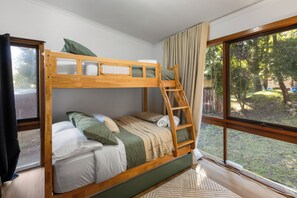 A bunk bed with a ladder, a window with curtains, and a view of the outdoors. - Diamond Lodge: 3  BR, 1  BA House in Sawmill Settlement, Sleeps 8 (Sawmill Settlement)