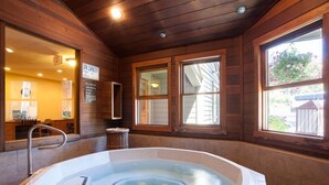 A spa with a capacity of 5 persons, a hot tub, wooden walls, and windows with a view. - 2BR Mountain Condo | Walk to Resort, Hot Tubs, Pool (Steamboat Springs)