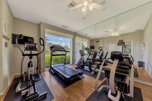 A modern home gym with cardio equipment, a treadmill, and a stationary bike. - Remodeled Siesta Key Villa – Steps to Private Beach & Village! (Sarasota)