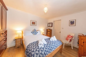 A bedroom with a bed, bedside tables, a chair, a wardrobe, and a door. - Quiet Green&Peaceful Home Near Reading University - Pass the Keys (Reading)