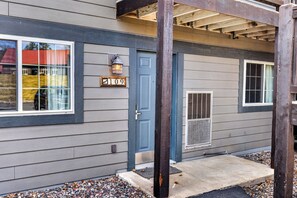 A residential building with a blue door, a number plaque, and a window with a metal grill. - Lake front Eagle River Chain of Lakes with indoor pool and jacuzzi! (Eagle River)