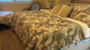 A bedroom with a bed, a chair, a lamp, and a ceiling fan. - Gulf-front paradise in Springtime on lovely Longboat Key 2/2 -2 pools,pickleball (Longboat Key)