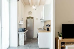 A modern kitchen with a refrigerator, microwave, and sink. - KeyRoom • Patio & Parking near Lake Como (Como)
