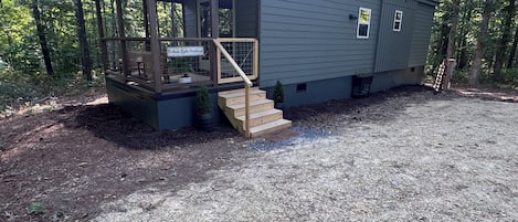 A small, single-story building with a porch and a sign that reads 'Northern Lights Farmhouse.'
