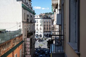 A narrow street with buildings on either side, a visible hotel sign, and a clear sky. - Standard · private kitchen & bath · Centrale (Naples)