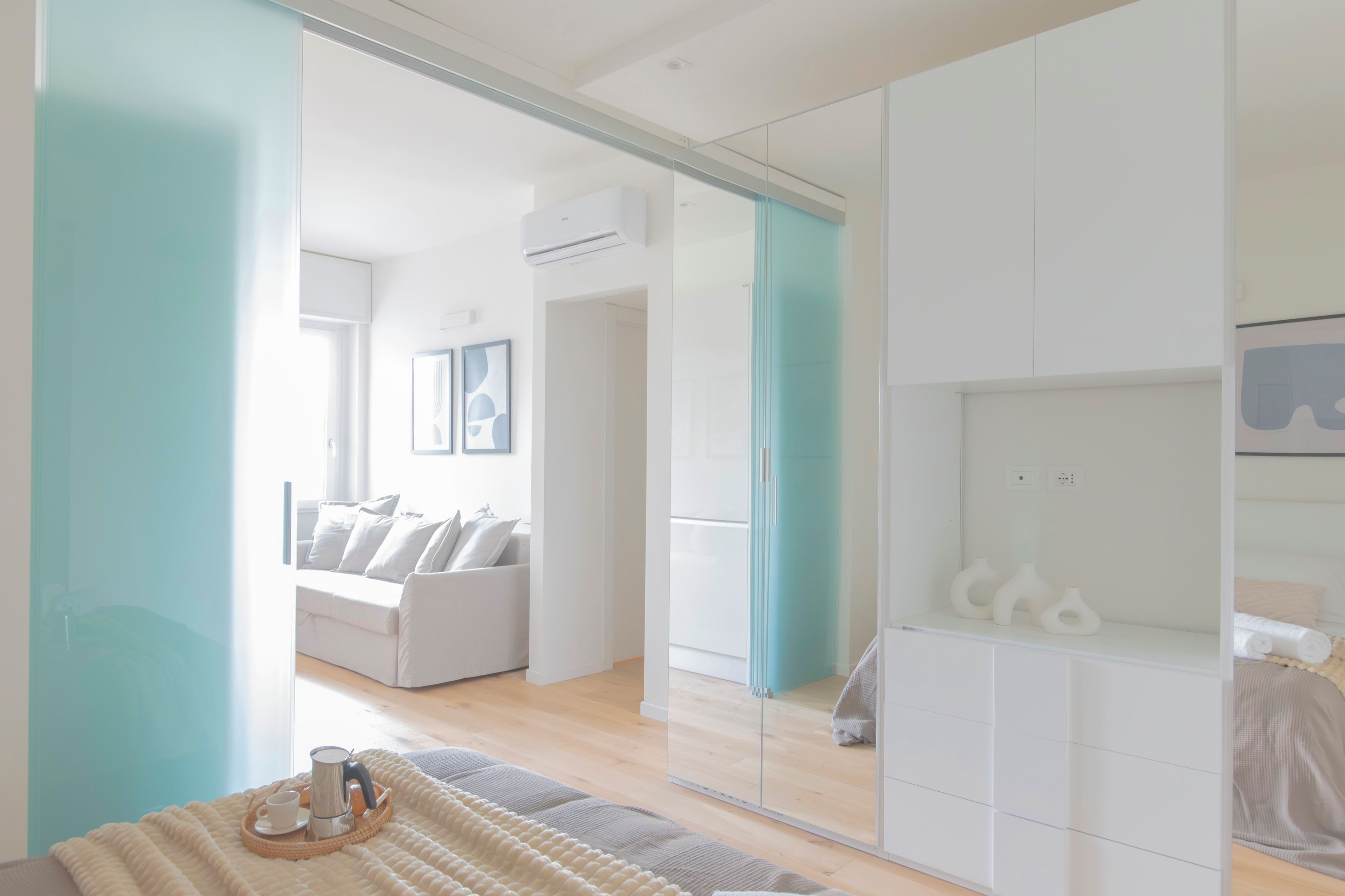 From the bed, past the glass door: the living room and its window.