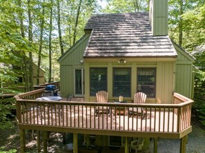 A wooden cabin with a deck, a table, and chairs. - Cozy cabin in Davis, WV 
Hibernation Station - Black Bear Resort (Davis)