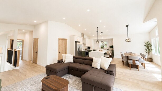 A spacious living area with a sectional sofa, a round coffee table, and a dining table with chairs. - South Lake Tahoe Home Near Heavenly, Edgewood Golf & beaches (SLT1040) (South Lake Tahoe)