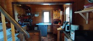 A wooden interior with a kitchen area, a sink, and a refrigerator. - The Cabrette Chalet, for 8 to 10 people—perfect for families (La Rivière-Enverse)
