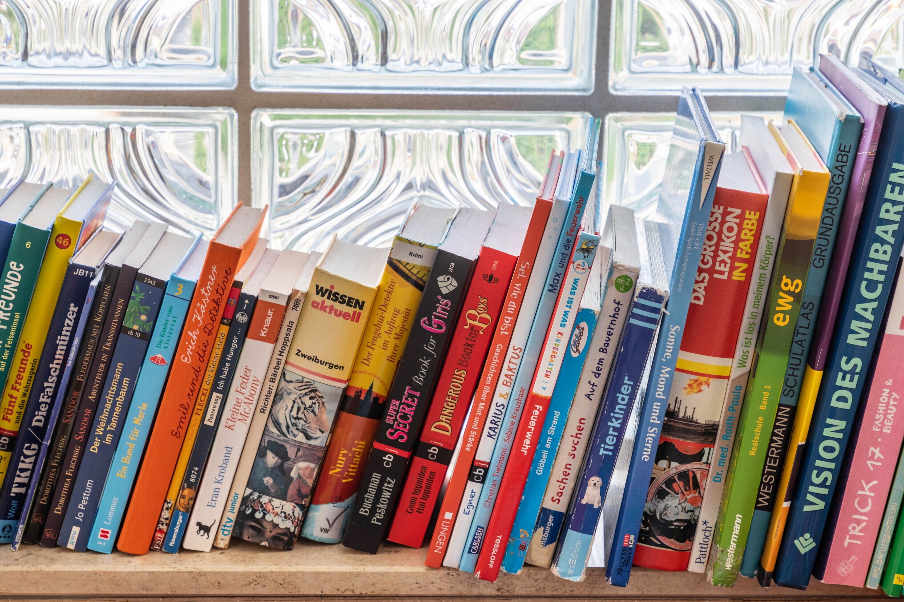 A bookshelf with a variety of books.