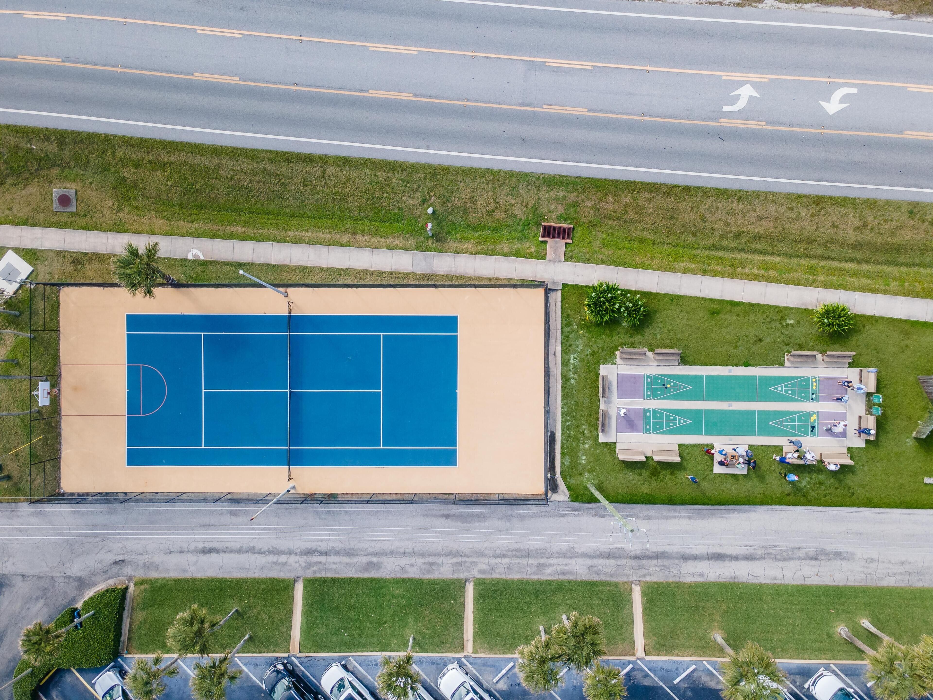 An aerial view of a sports facility with a basketball court and shuffleboard tables.