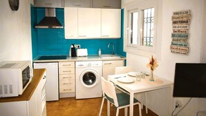 A compact kitchen with a washing machine, a microwave, and a toaster. - Ap1139 in Denia With 1 Bedrooms and 1 Bathrooms (Denia)