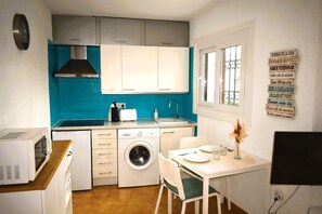 A compact kitchen with a washing machine, a microwave, and a toaster. - Ap1139 in Denia With 1 Bedrooms and 1 Bathrooms (Denia)
