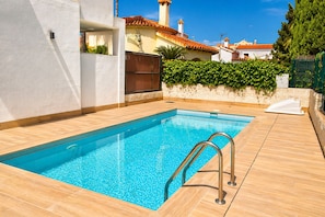 A rectangular swimming pool with a metal ladder, surrounded by a tiled deck. - Ap115 in Oliva With 2 Bedrooms and 1 Bathrooms (Oliva)