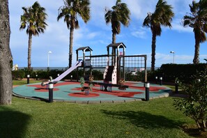 A playground with a slide, swings, and climbing structures.