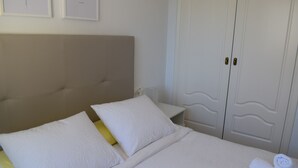 A hotel room with a bed, a nightstand, and a wardrobe. - Pb3201 in Denia With 3 Bedrooms and 2 Bathrooms (Denia)