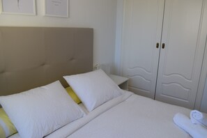 Ein Hotelzimmer mit einem Bett, einem Nachttisch und einem Kleiderschrank.