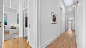 A hallway with white walls, wooden flooring, and a ceiling with skylight. - Casa Estrela, a mansion in the heart of Olhão, (Olhão)