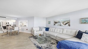 A modern living room with a sofa, coffee table, and artwork on the wall. - Top Floor Gulf View Condo at South Seas Tower IV. (Marco Island)