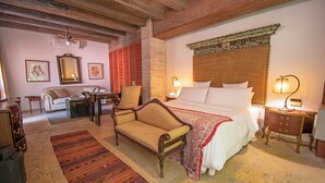 A traditional room with a bed, a sofa, a chair, a desk, and a lamp. - Casa Mejia (Cartagena de Indias)