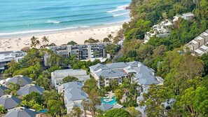 A coastal residential area with a beach, dense greenery, and modern buildings. - French Quarter 322 Beautiful One Bedroom Apartment (Noosa Heads)