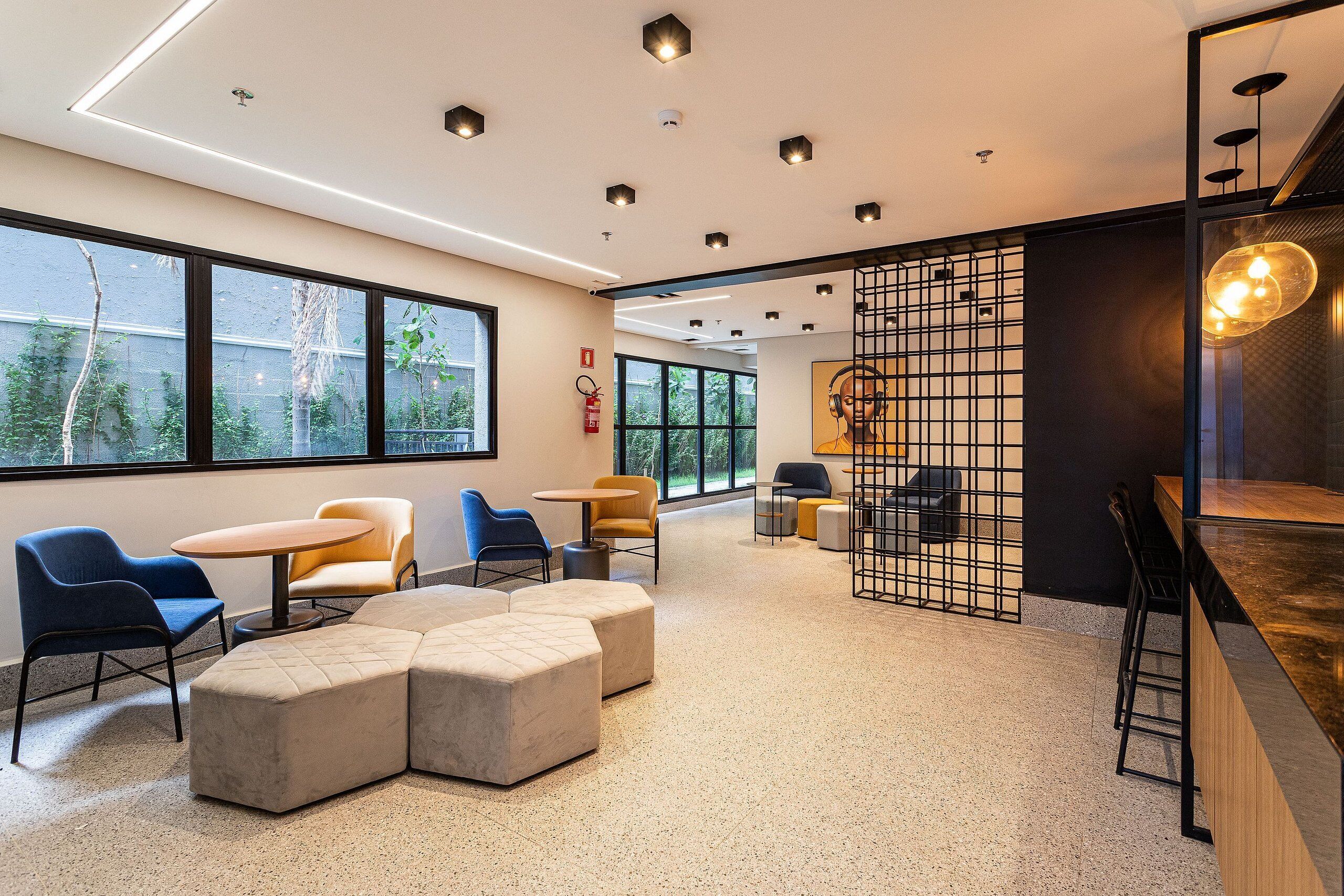A modern interior with seating areas, a bar, and large windows.