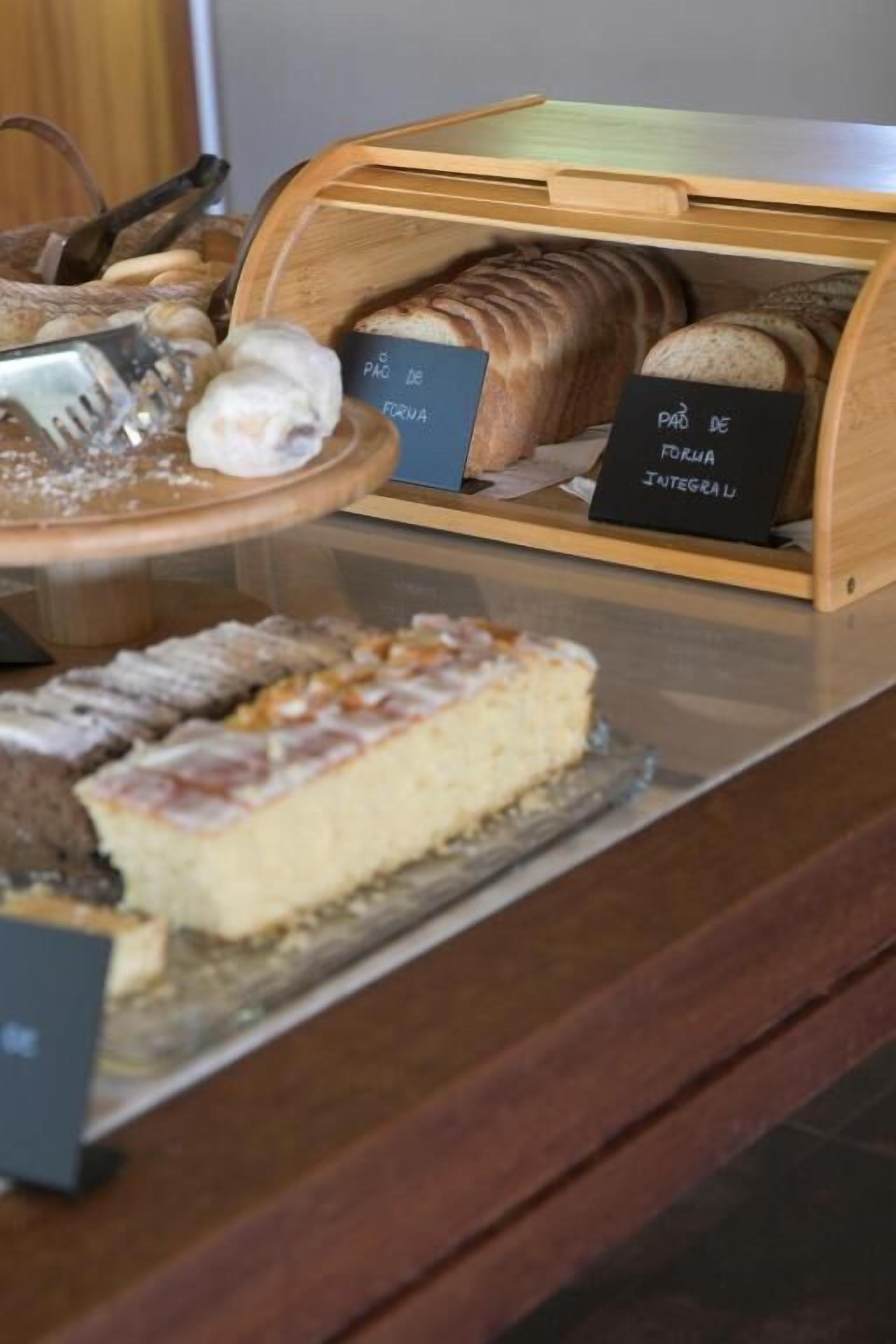 A bakery display with pastries and a slice of cake on a tray.