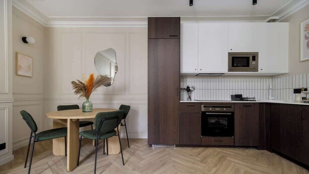 A modern kitchen with white cabinetry, a microwave, and a built-in oven. - Rousselet - Amazing Parisian Flat in the 7th (Paris)