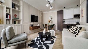 A modern living room with a sofa, armchair, and a coffee table. - Rousselet - Amazing Parisian Flat in the 7th (Paris)