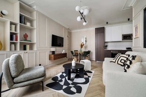 A modern living room with a sofa, armchair, and a coffee table. - Rousselet - Amazing Parisian Flat in the 7th (Paris)