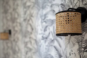 A wall-mounted lamp with a perforated design. - Poissonnière – Cosy Apartment near Montmartre (Paris)