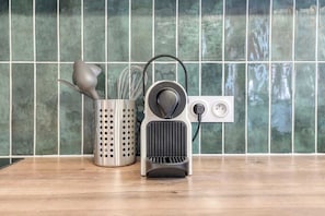A kitchen counter with a coffee maker, a grater, and a whisk set. - Poissonnière – Cosy Apartment near Montmartre (Paris)
