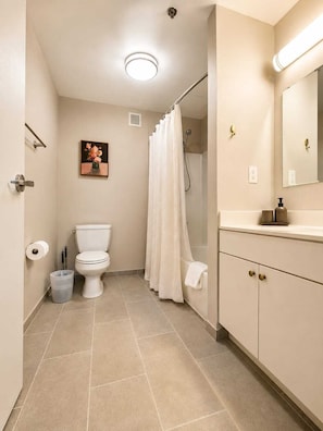 A bathroom with a toilet, shower, and vanity. - Beautiful 2BR Center City Gem | By Rafa Properties (Philadelphia)