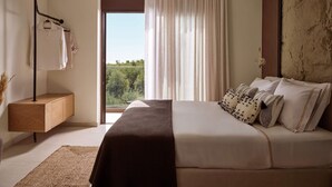 A bedroom with a bed, a bedside table, a hanging light, and a view through a window. - Villa Aelionis, Private Pool, Furnished Terrace, Zakynthos (Zakynthos)