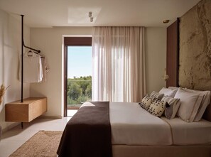 A bedroom with a bed, a bedside table, a hanging light, and a view through a window. - Villa Aelionis, Private Pool, Furnished Terrace, Zakynthos (Zakynthos)