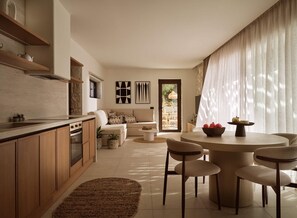 A modern kitchen with wooden cabinets, a dining area with a round table and chairs, and a living area with a sofa and a coffee table. - Villa Aelionis, Private Pool, Furnished Terrace, Zakynthos (Zakynthos)