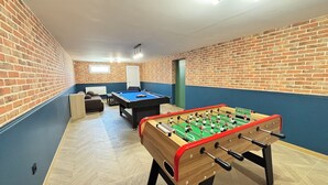 A room with a foosball table, a pool table, and a sofa. - Villa César - Private padel court, heated pool from March through November. (Bransles)
